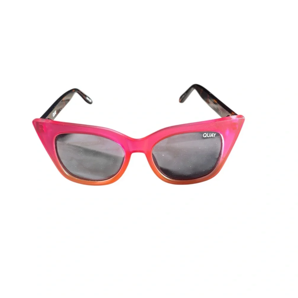 Quay Harper Kids cat-eye sunglasses with coral pink and smoke lenses.